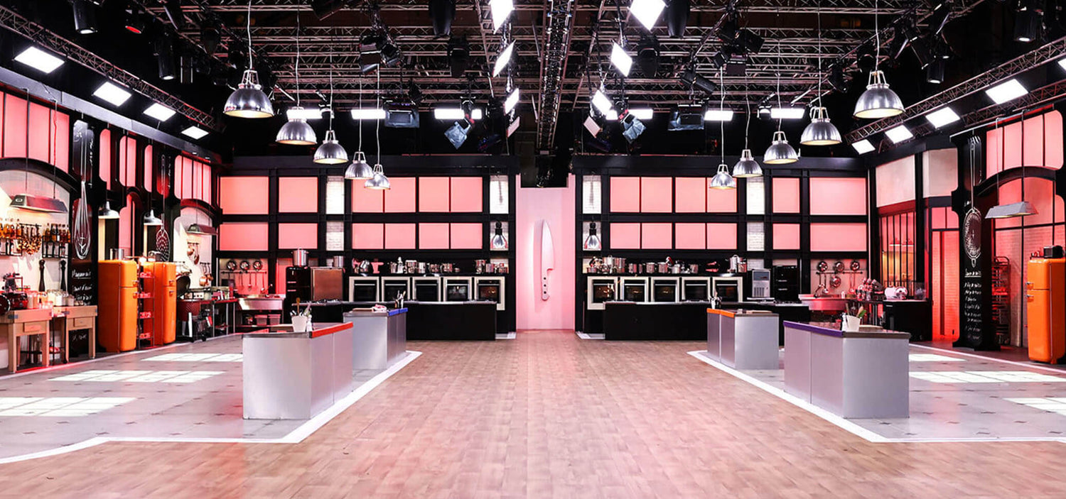 Top Chef set with professional kitchens, central workstations, and studio lighting.