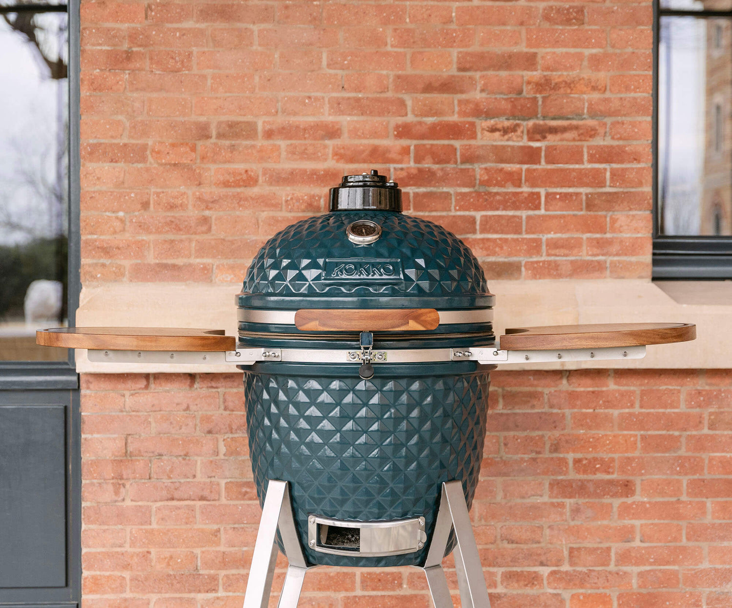 Kamado Kokko new edition displayed on its cart, highlighting the design, textured ceramic, and seamless integration into an outdoor space.