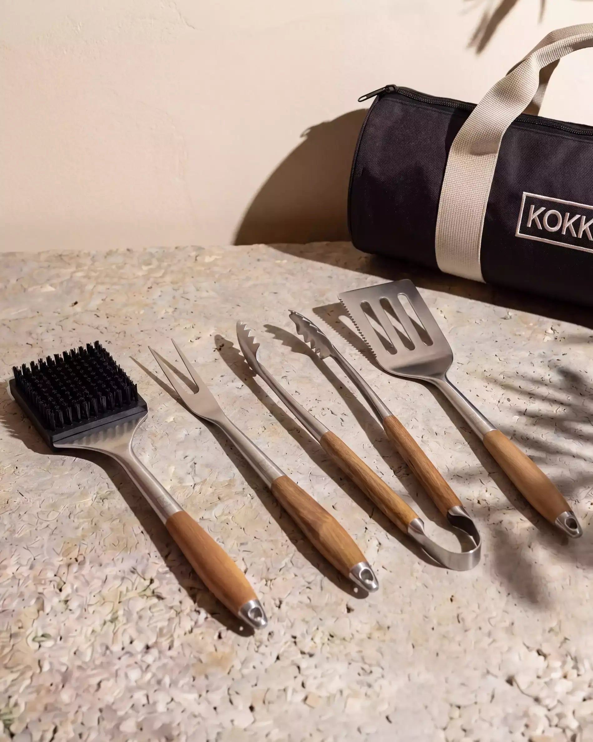 Kokko 4-Piece Barbecue Utensil Set (brush, fork, tongs, spatula) with wooden handles and storage pouch