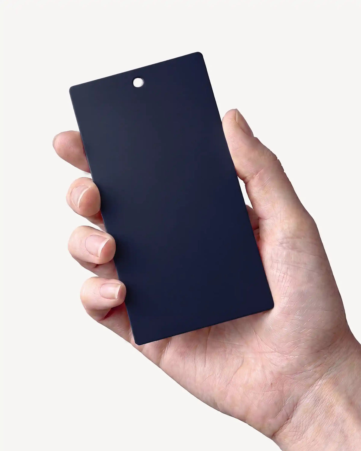 Hand holding a Navy Blue PILOTIS color sample
