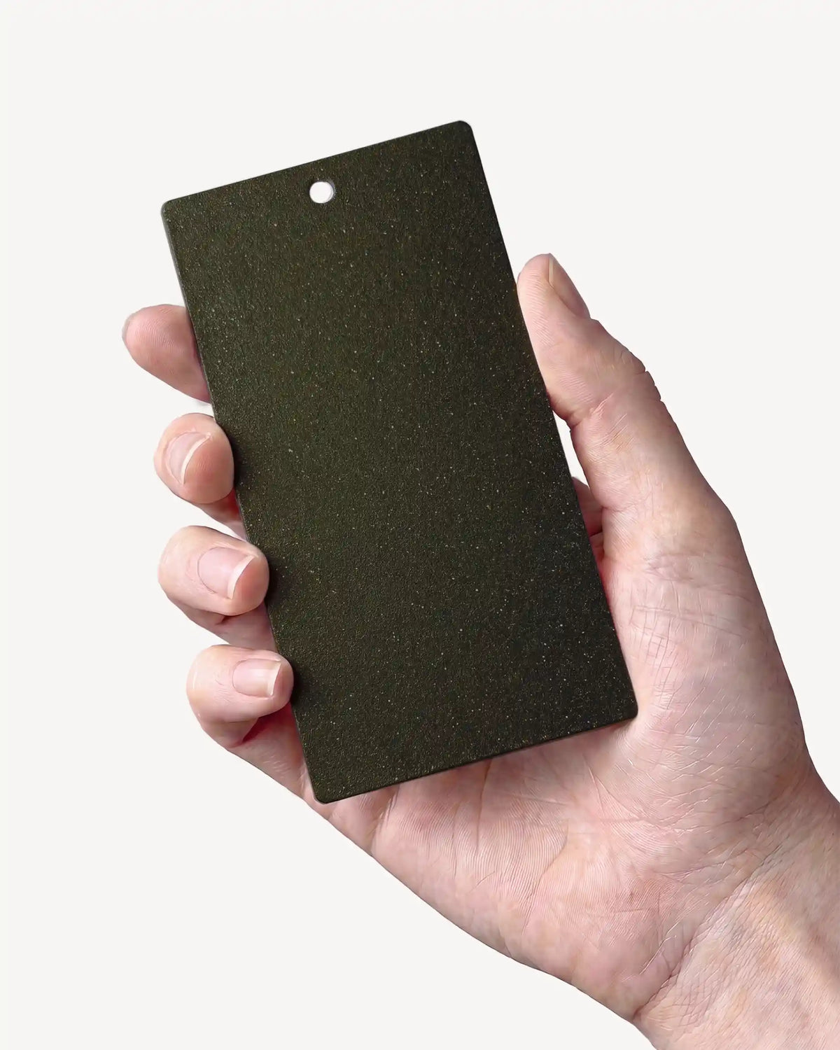 Hand holding a sample in Olive Green PILOTIS