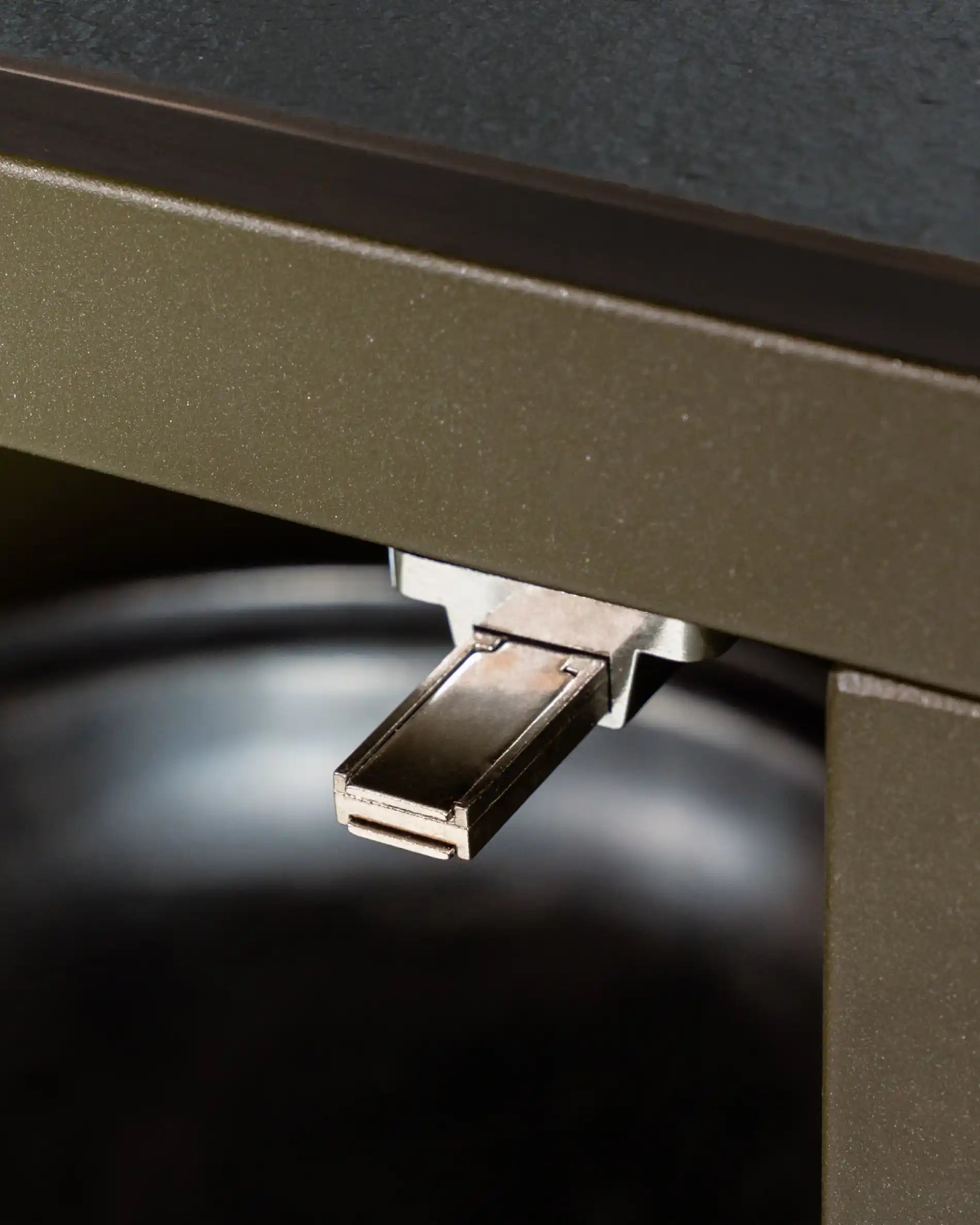 Close-up view of the PILOTIS metal hinge mounted on the corner of the furniture
