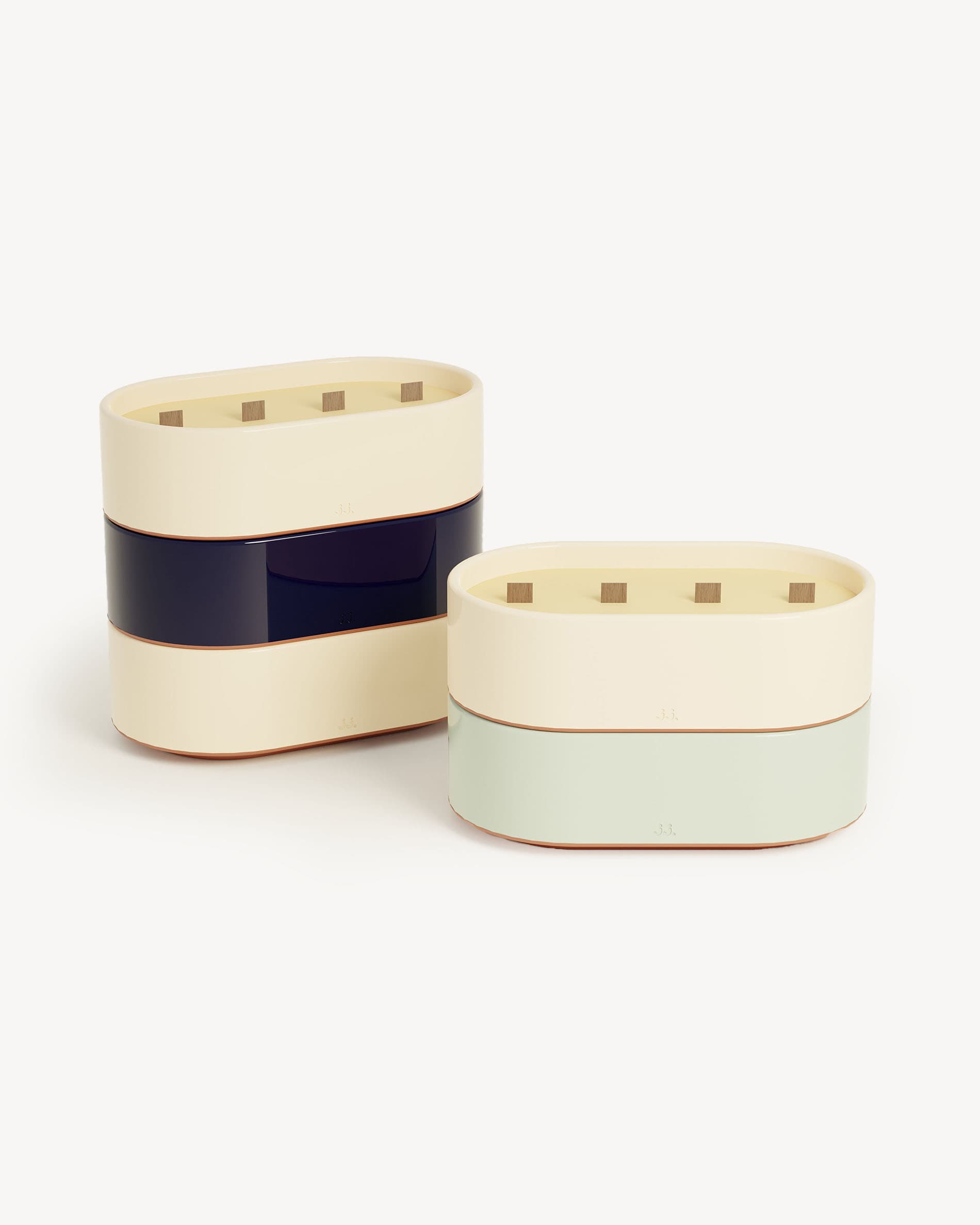 Totem L candles in ivory beige and water green glazed ceramic, scented with citronella and notes of lemon and eucalyptus.