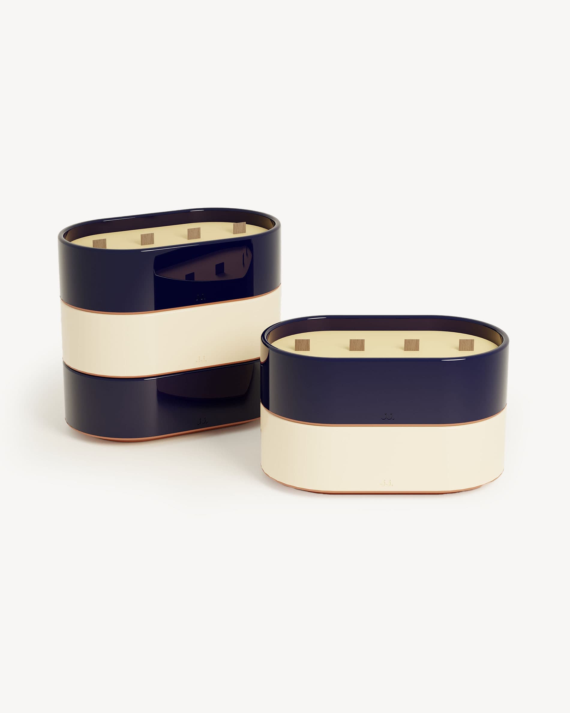 Totem L candles in ivory beige and navy blue glazed ceramic, scented with citronella and notes of lemon and sea salt.