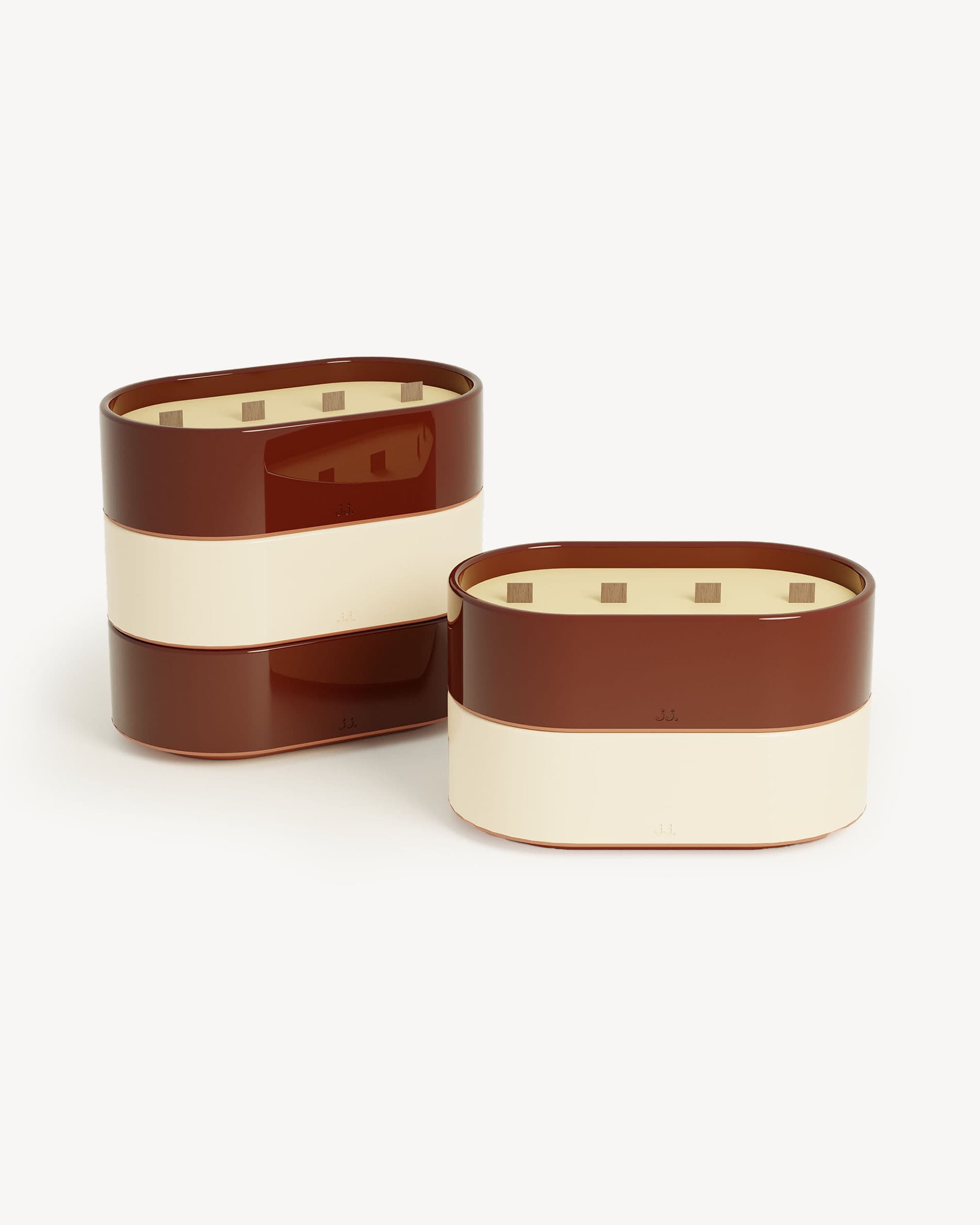 Totem L candles in ivory beige and oxide red glazed ceramic, scented with citronella and notes of lemon and geranium.
