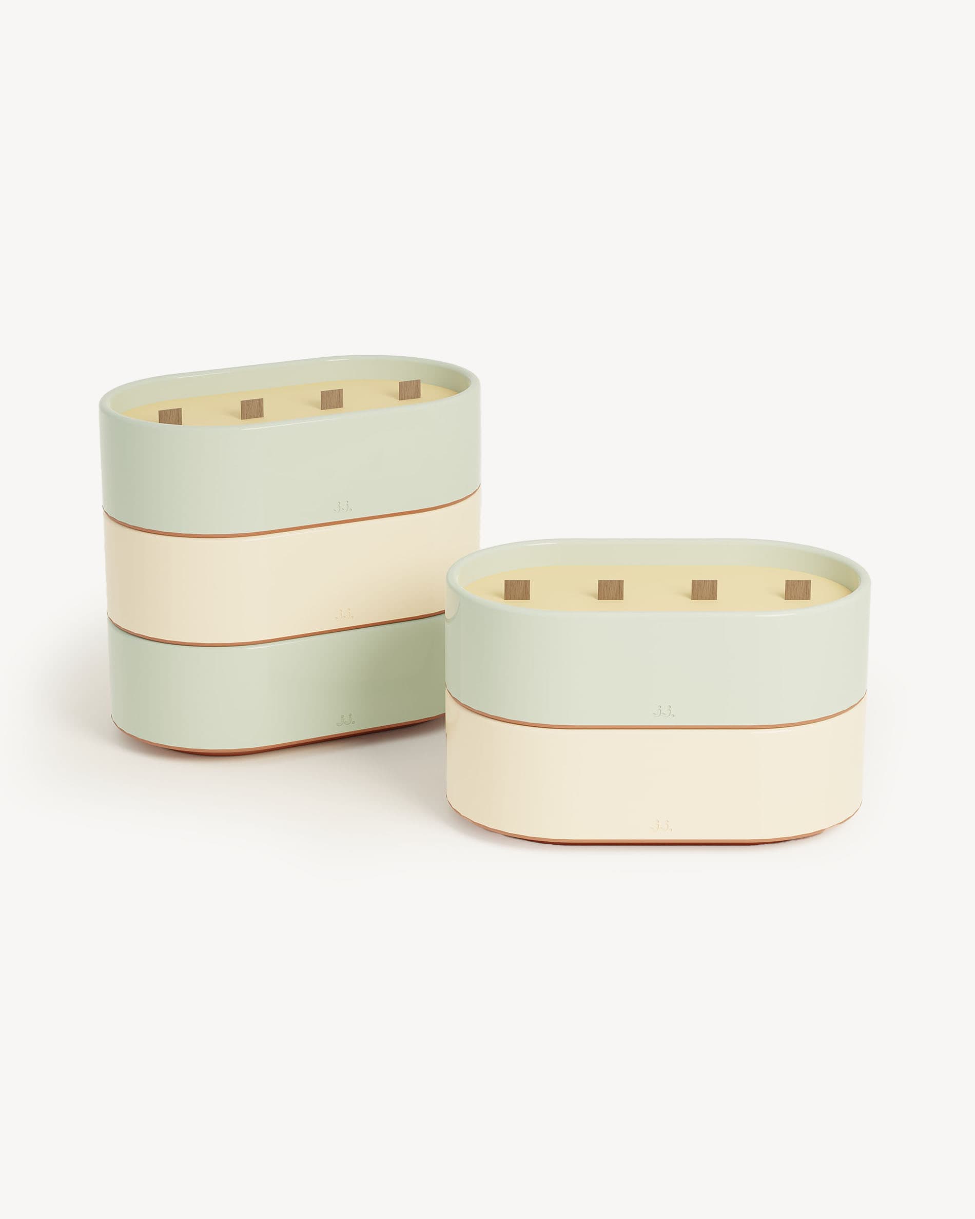 Totem L candles in ivory beige and water green glazed ceramic, scented with citronella and notes of lemon and eucalyptus.
