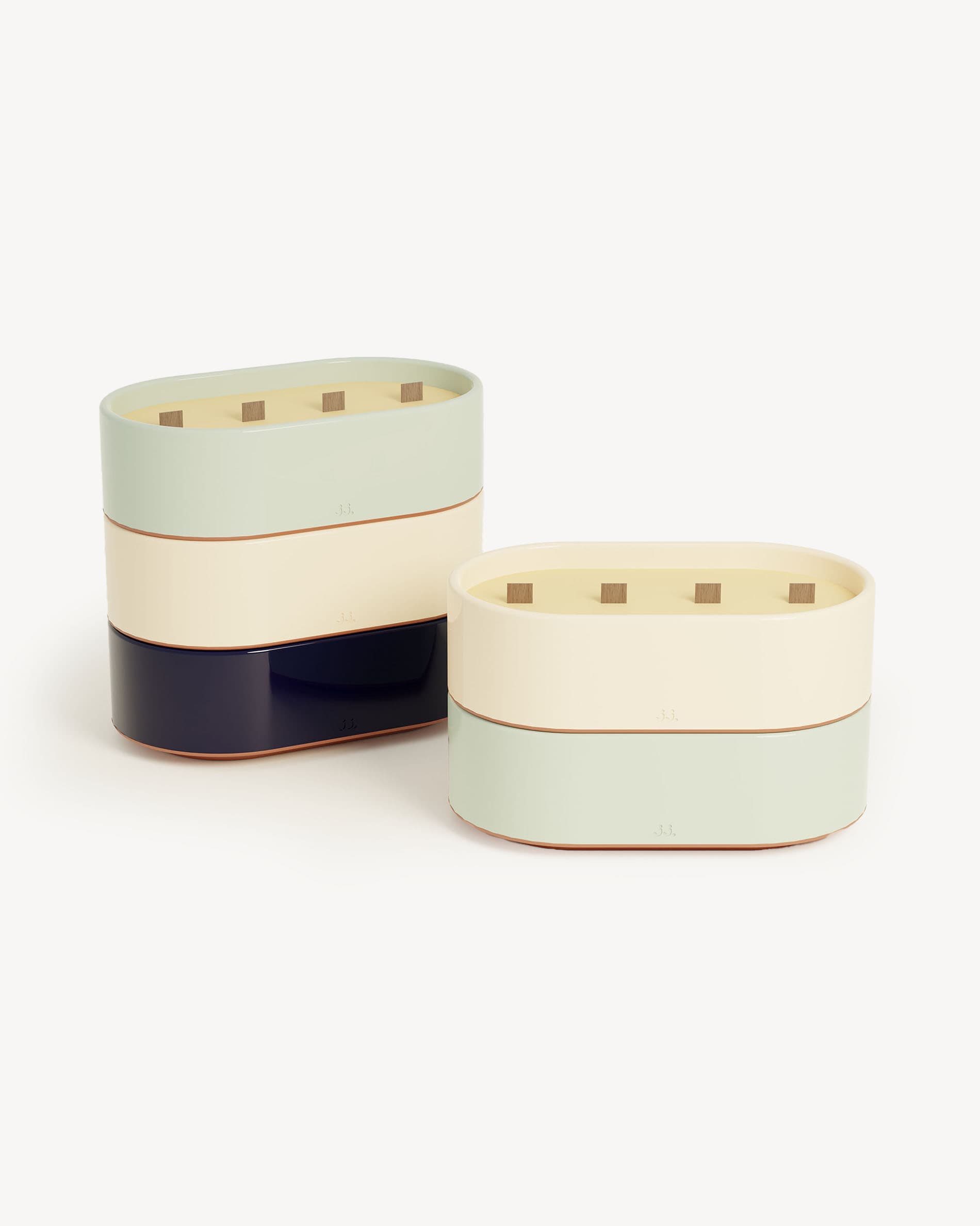 Totem L candles in ivory beige and water green glazed ceramic, scented with citronella and notes of lemon and eucalyptus.