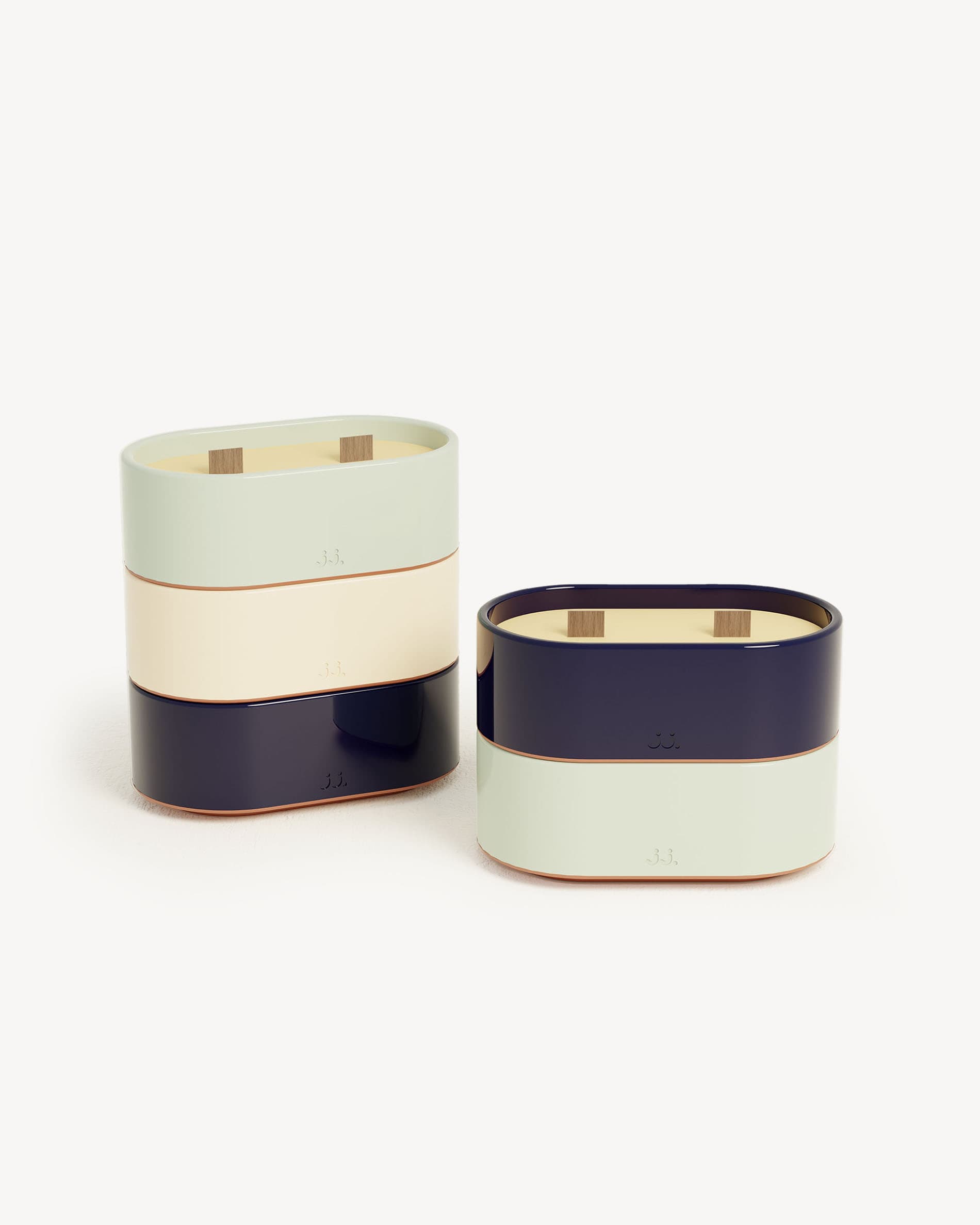 Totem S candles in water green and navy blue ceramic, scented with citronella and notes of eucalyptus and sea salt.