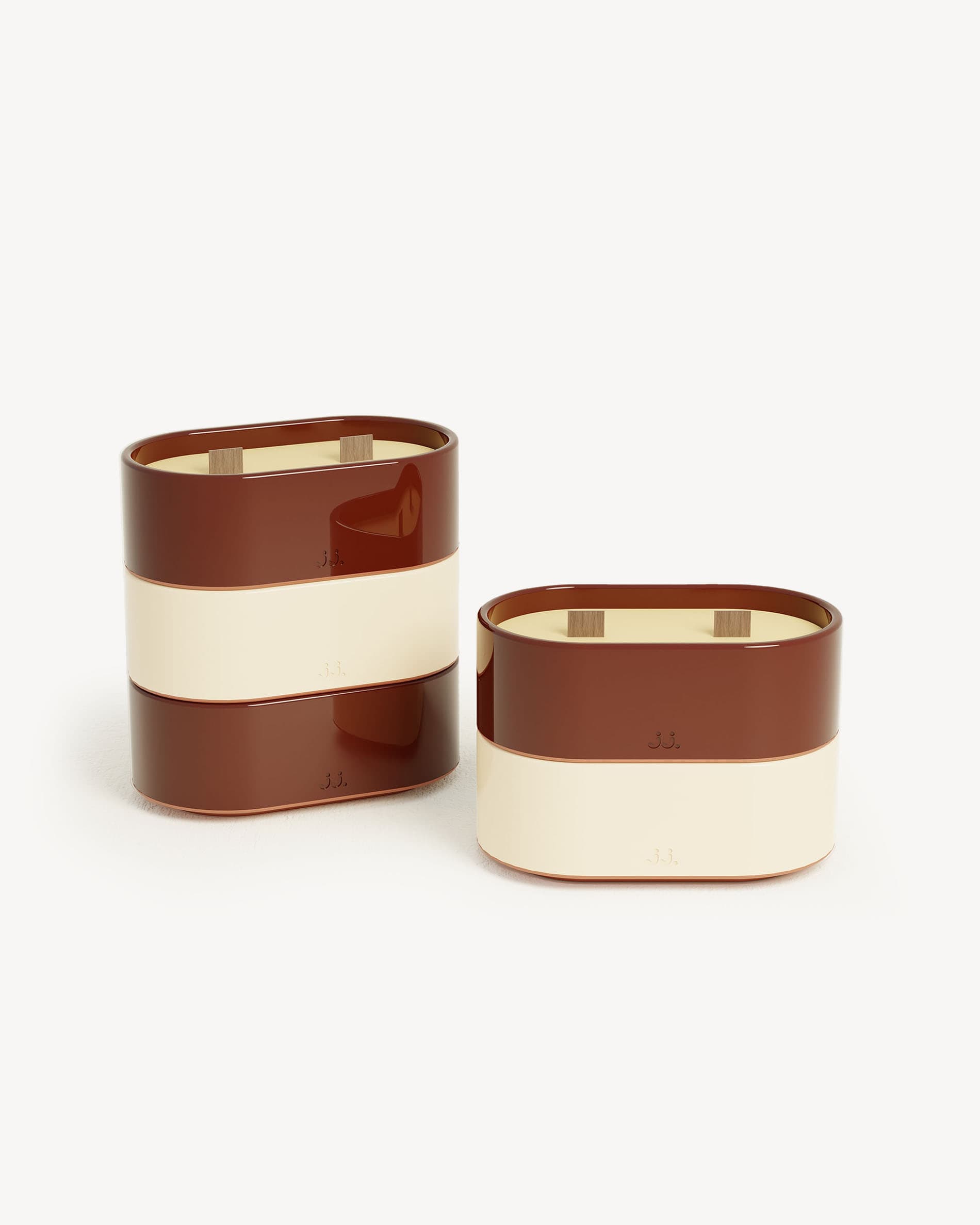 Totem S candles in ivory beige and oxide red glazed ceramic, scented with citronella and notes of lemon and geranium.
