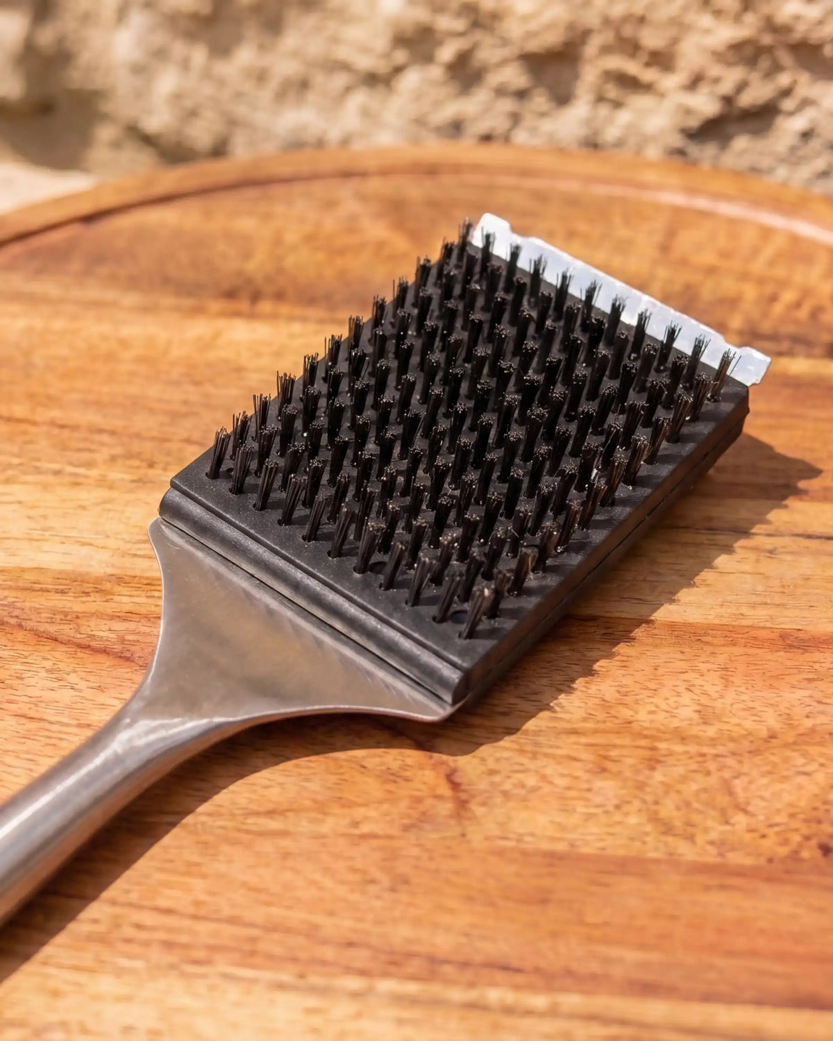 Kokko stainless steel and acacia brush placed on a wooden board