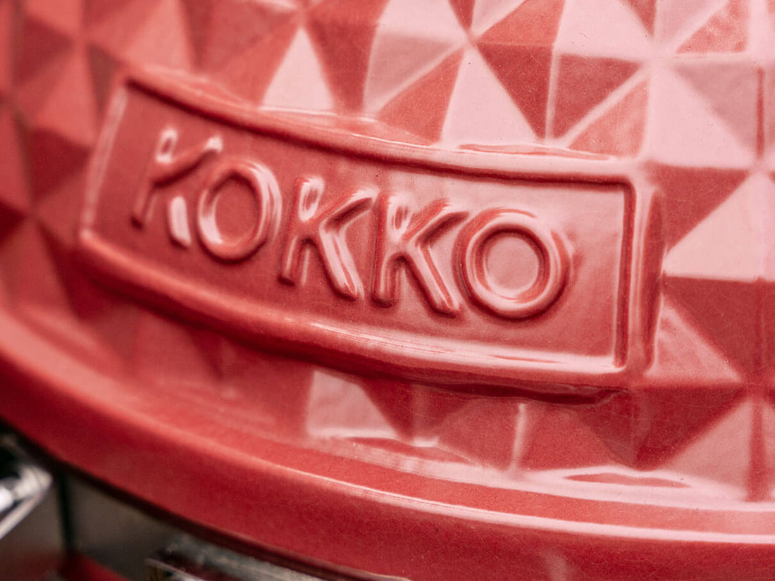 Close-up of the Kokko logo embossed on the red ceramic of the kamado.
