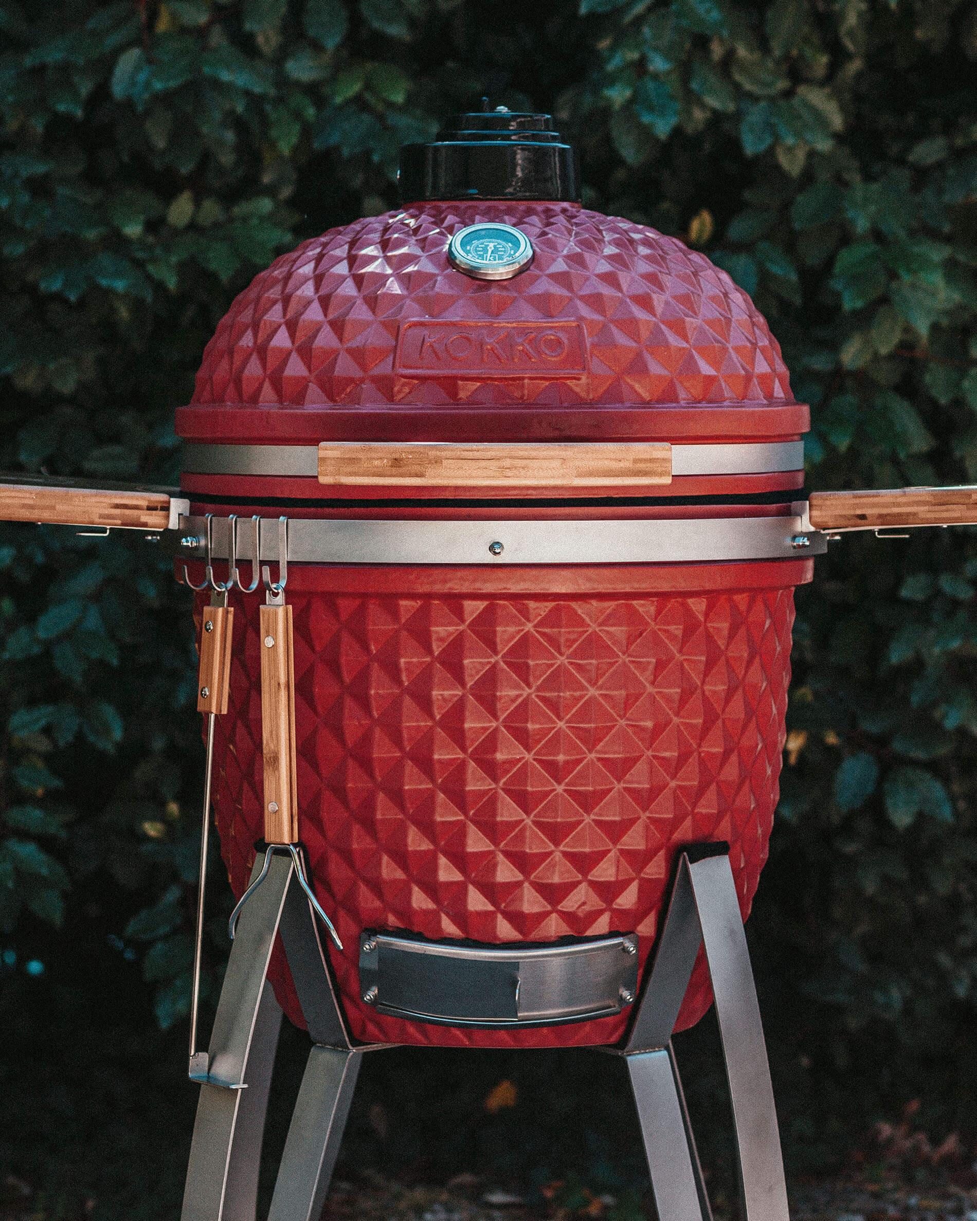 Red Kokko kamado fitted with accessory hooks.