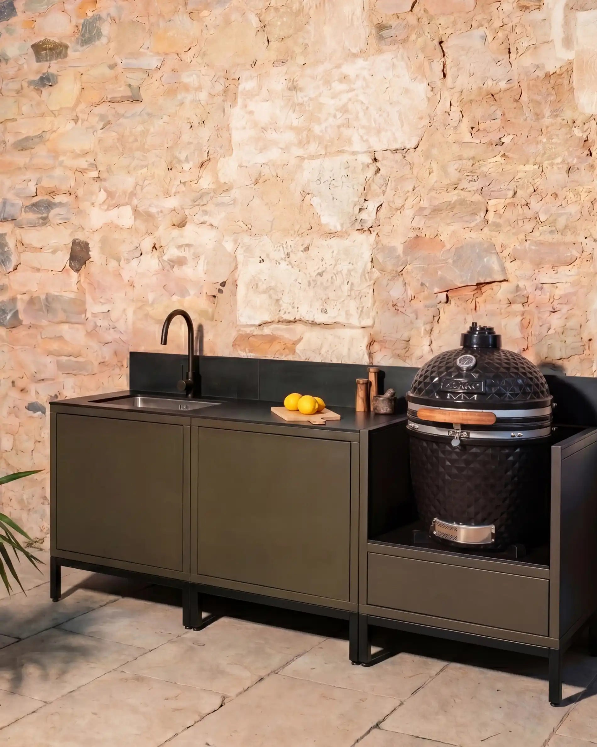 Kokko olive outdoor kitchen with black sink and integrated kamado