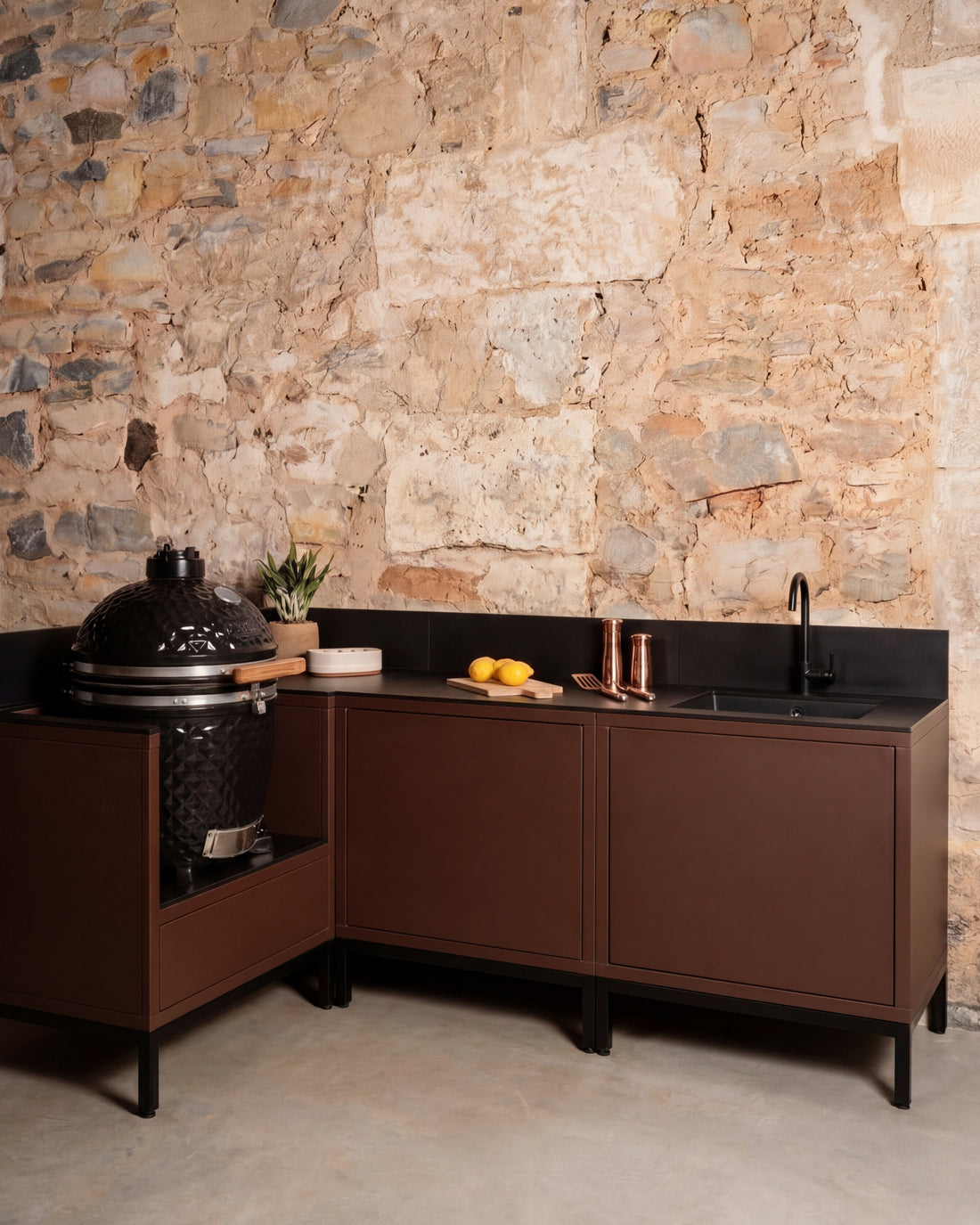 Kokko Pilotis corner outdoor kitchen in rust color with sink and built-in kamado