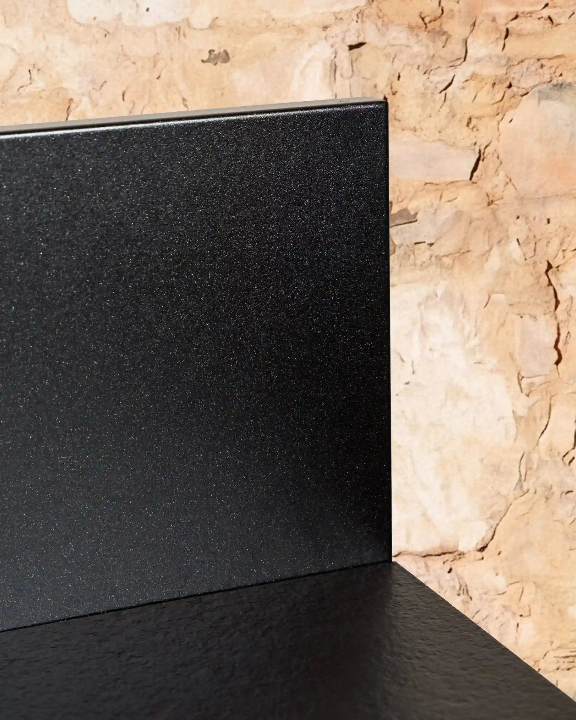 Black backsplash and worktop detail of Kokko outdoor kitchen