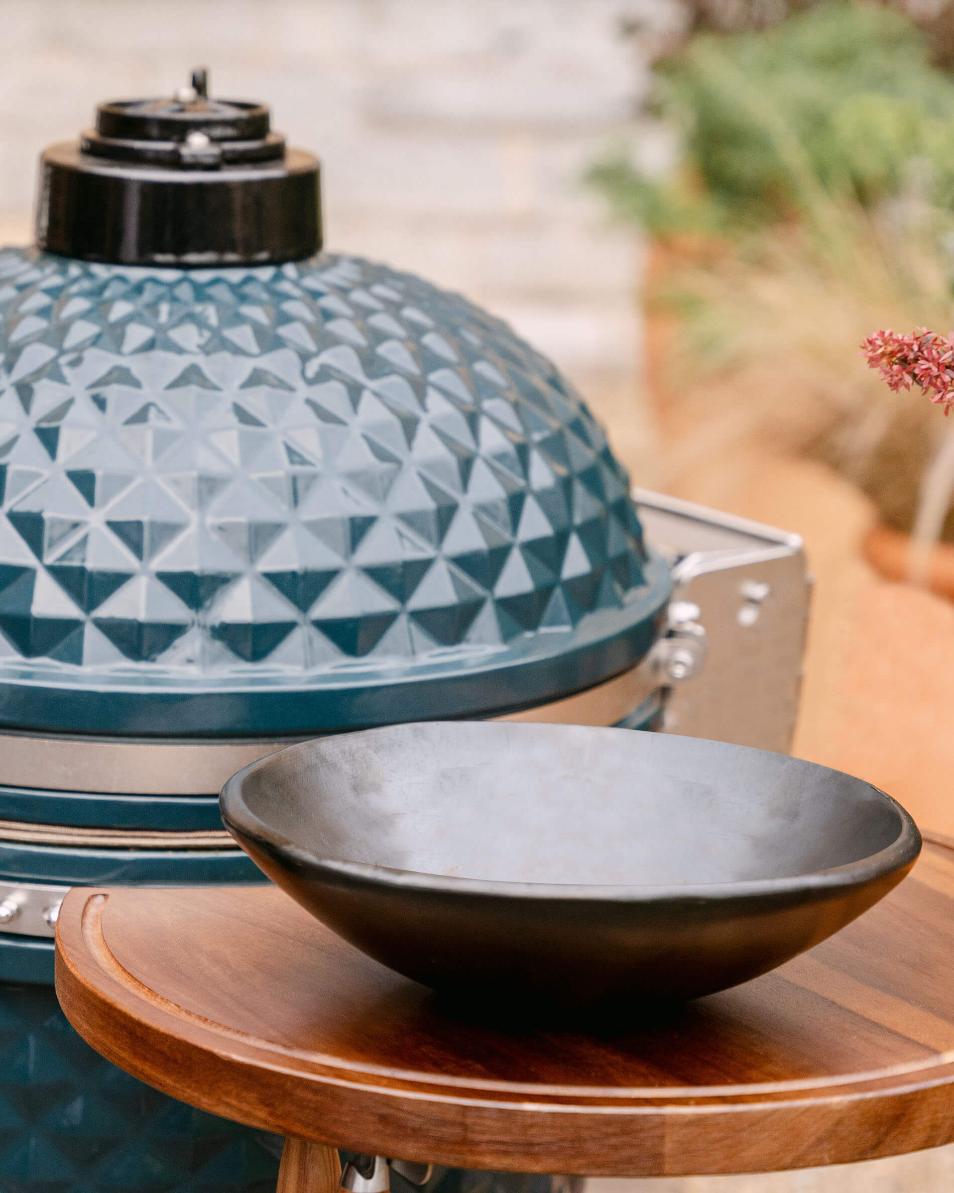 Large black Chamba clay bowl in front of the kamado