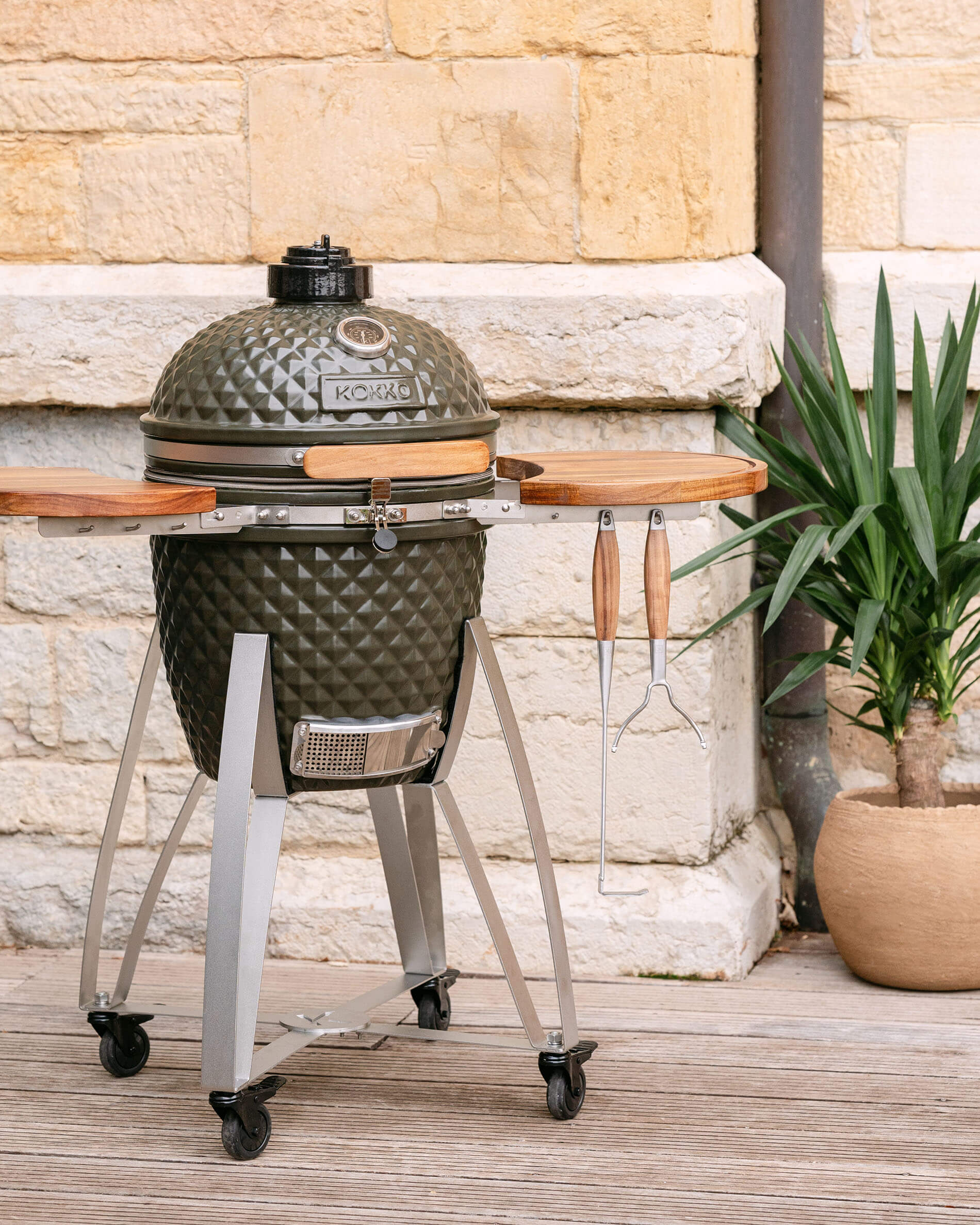 Kokko L 18-inch olive green ceramic kamado set on a cart.