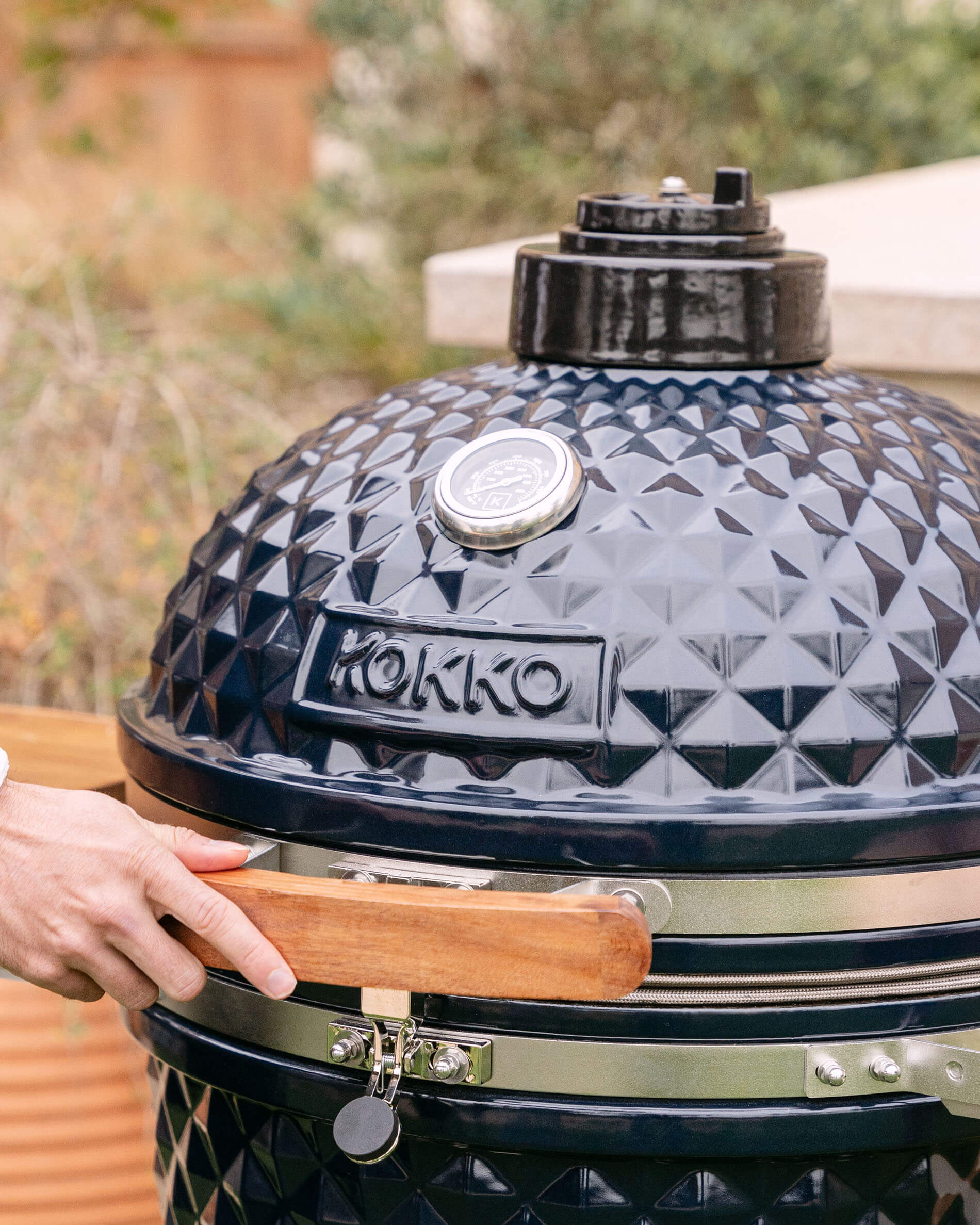Close-up of the lid of a Kokko XL 22-inch navy blue ceramic kamado.