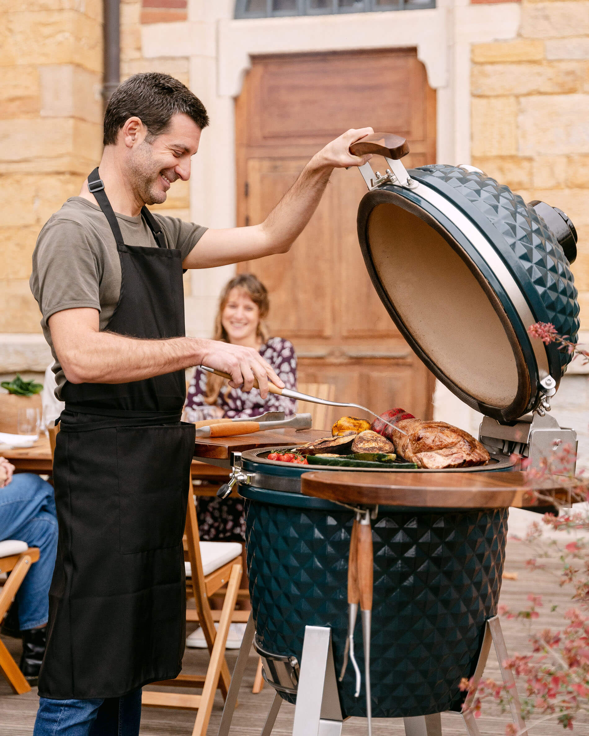 Ceramic Kamado Kokko XL 22-inch in Ocean Blue being used.