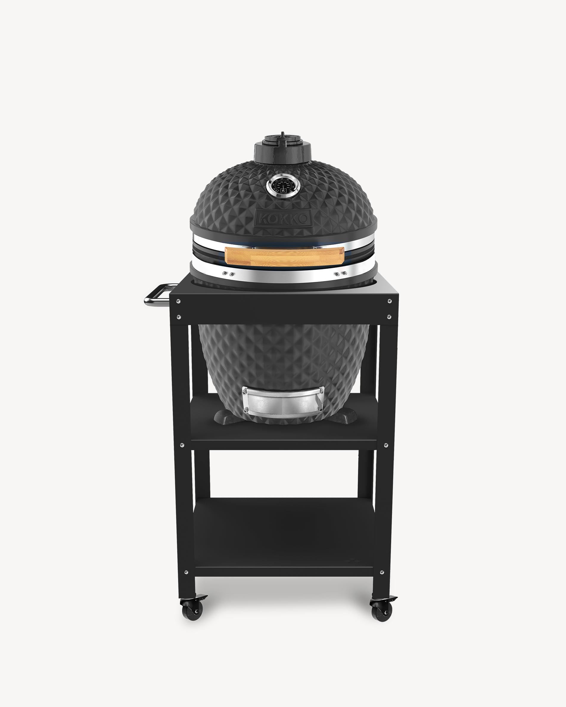 Kokko L 18-inch black kamado barbecue, set up on a trolley with storage and wheels