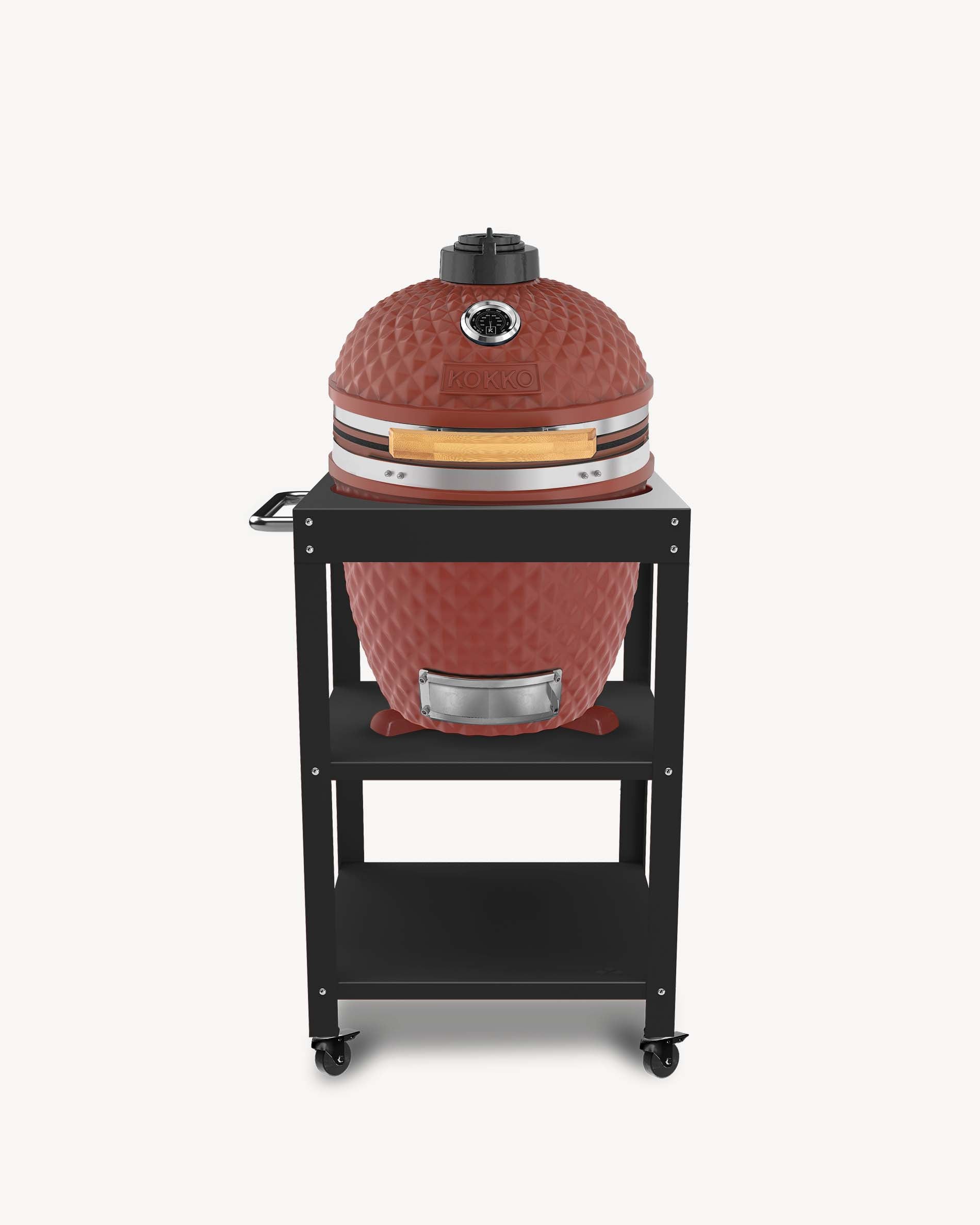 Kokko L 18-inch kamado barbecue in oxide finish, set on a trolley with storage and wheels.