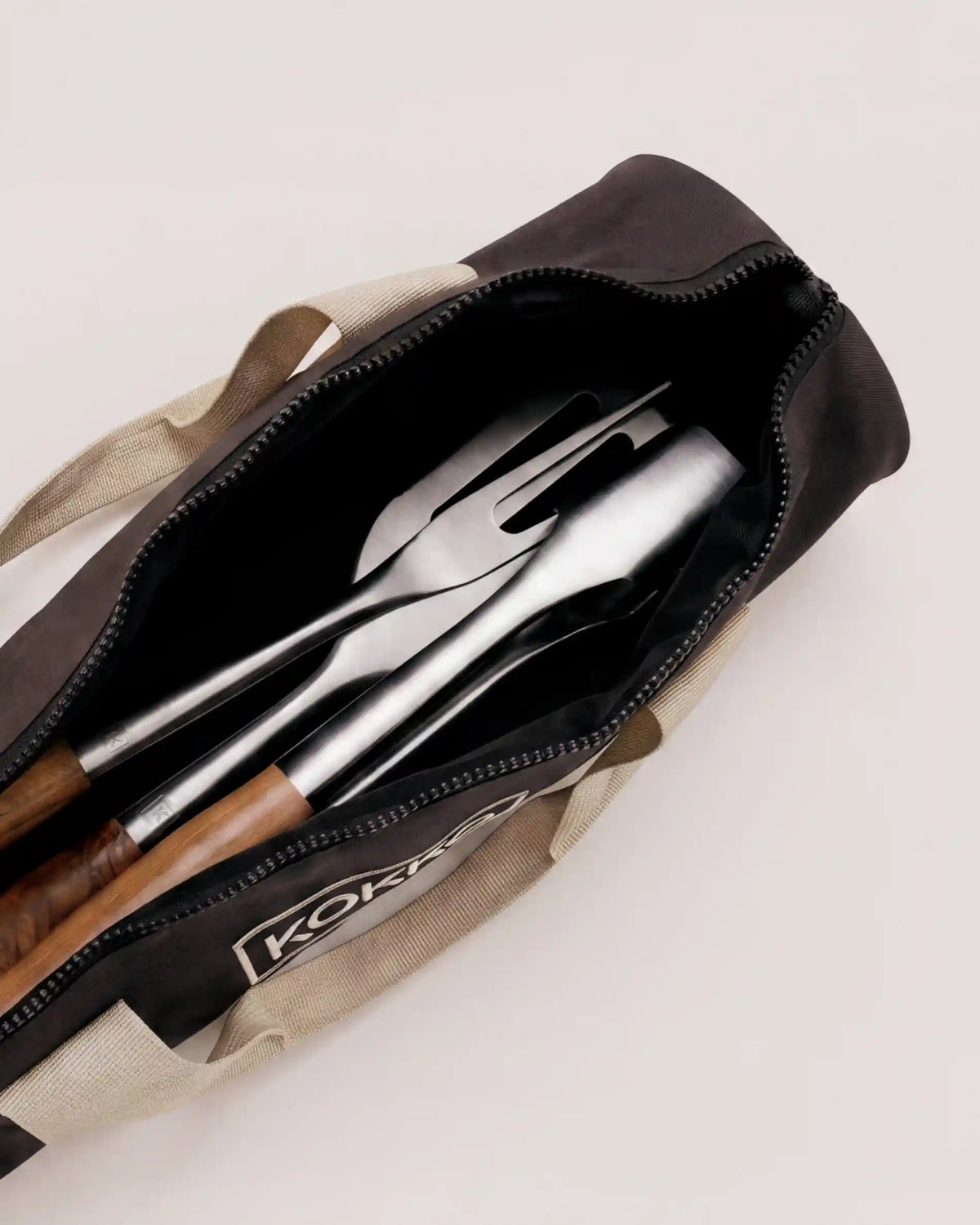 Kokko cover open with stainless steel and acacia utensils inside