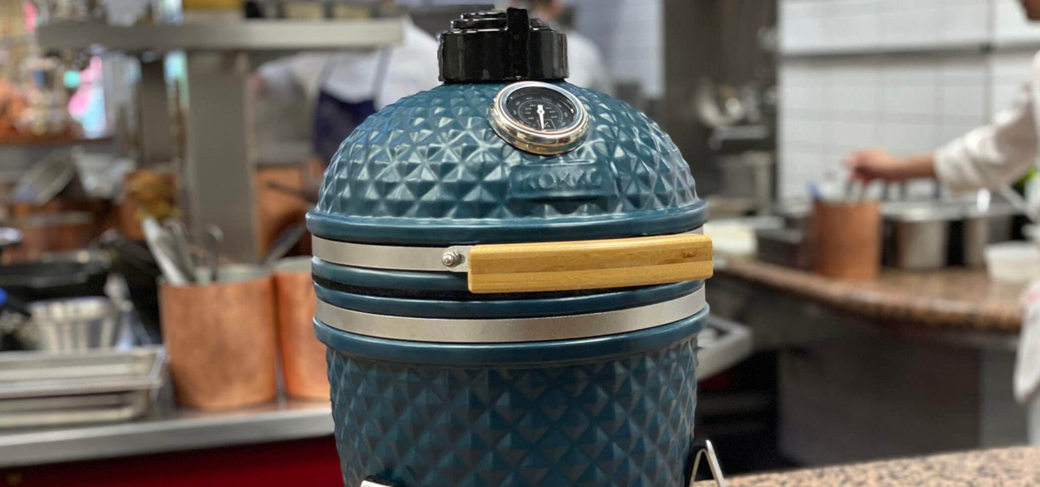 Ocean blue Kokko kamado set up in front of a Paul Bocuse fine dining restaurant.