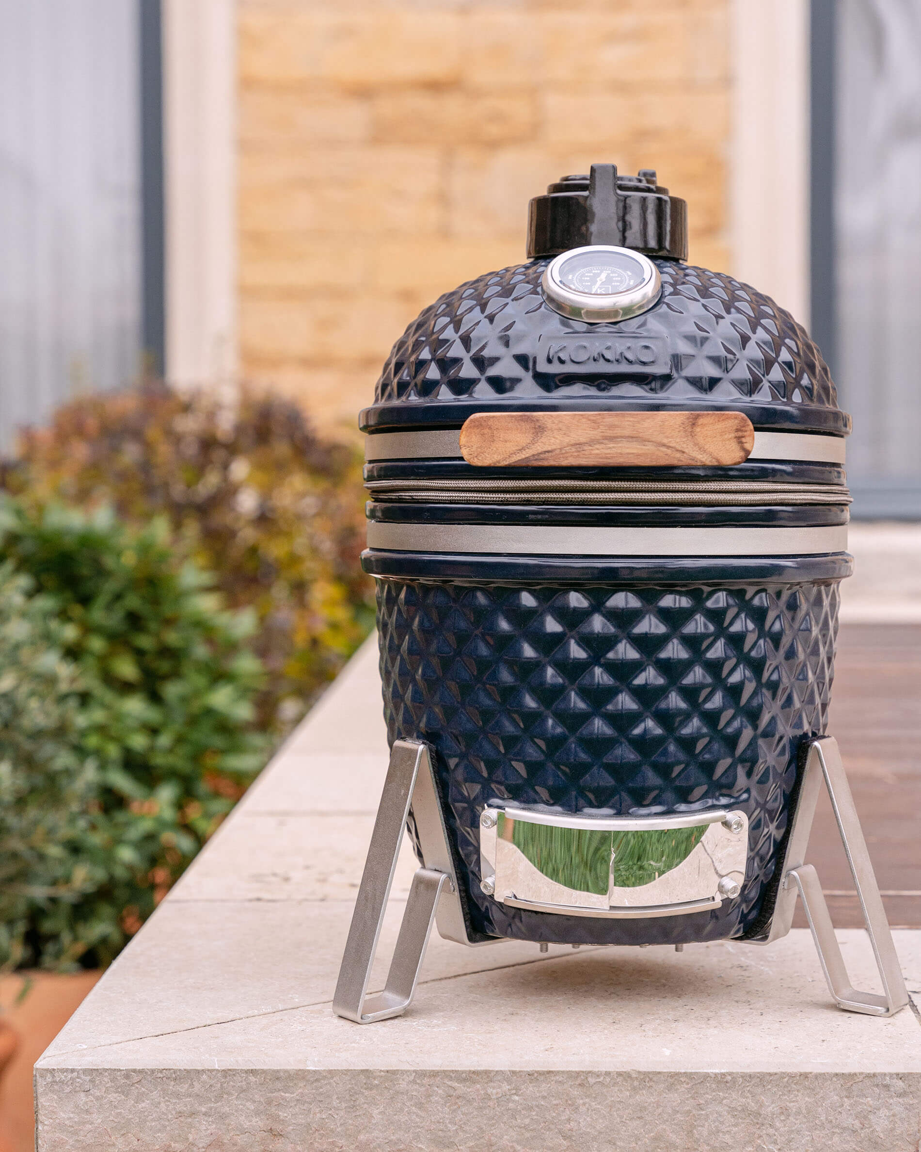Navy blue Little Kokko 13 ceramic kamado set on its stand.