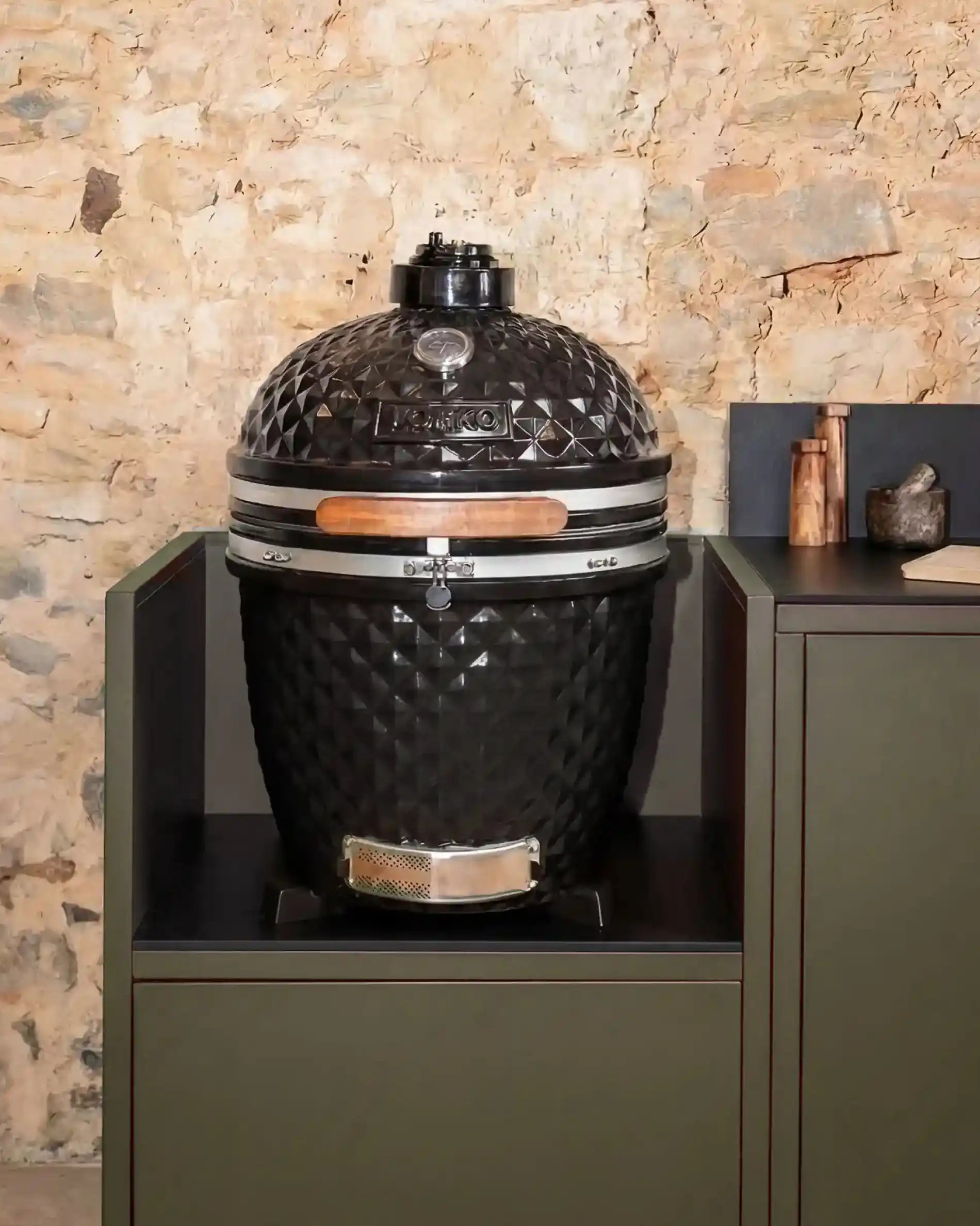 Black Kokko kamado built into olive module with black worktop