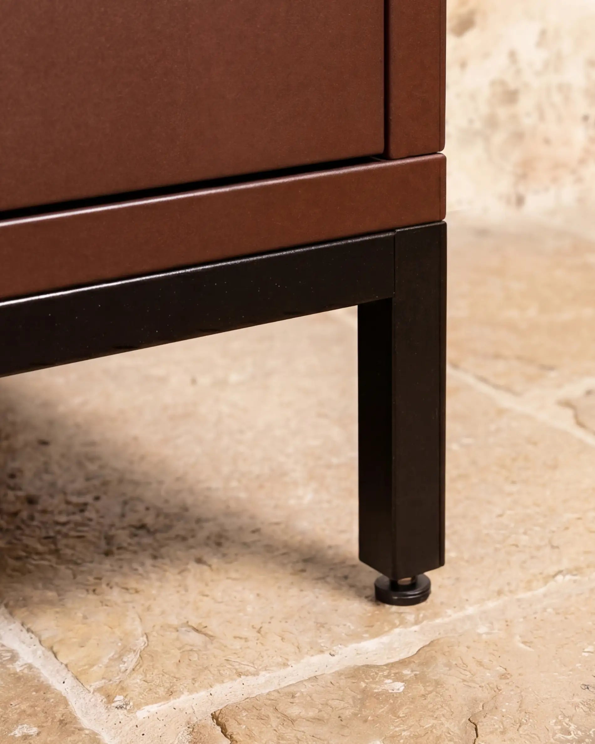 Black metal leg under Kokko rust outdoor kitchen unit