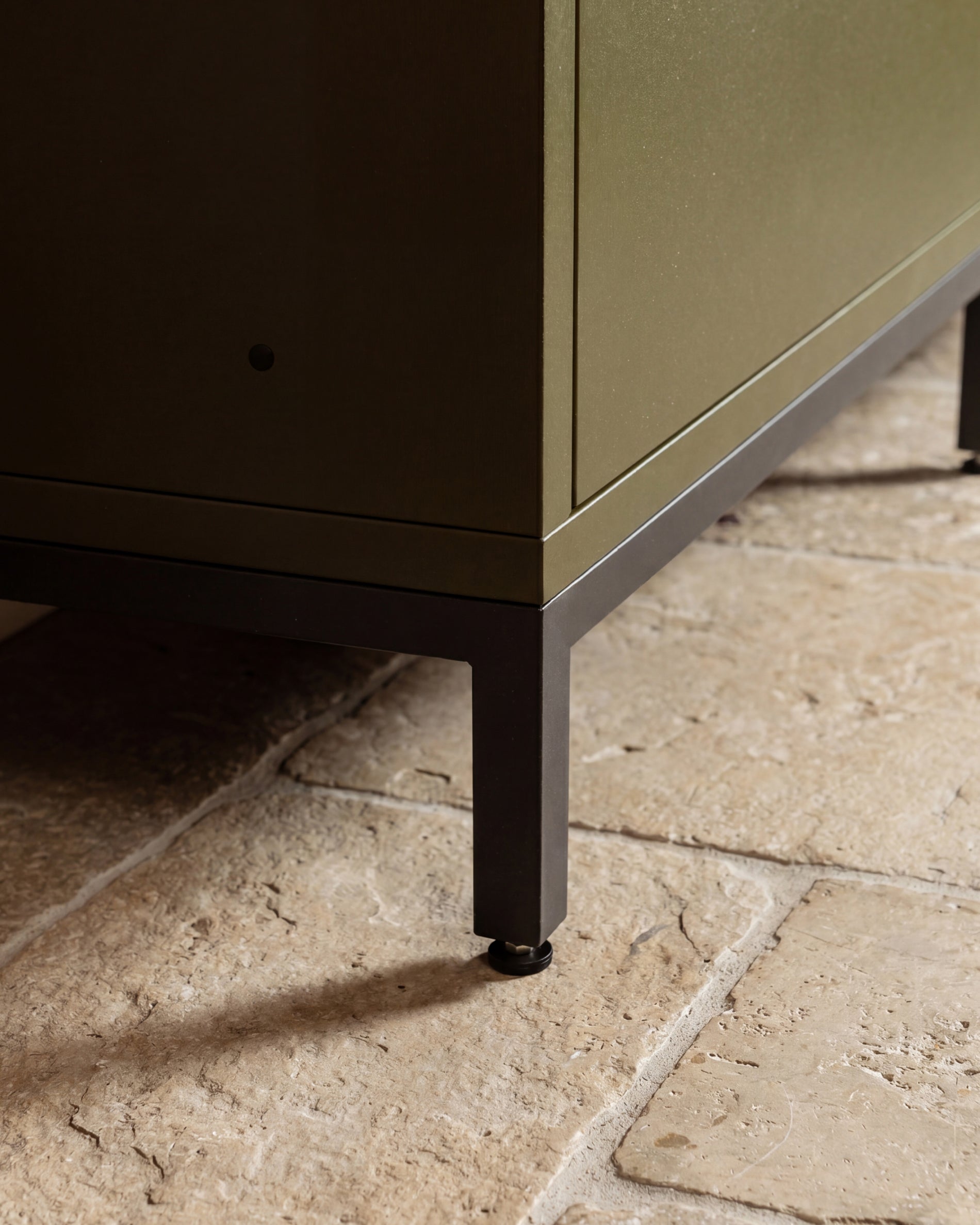 Detail of black metal leg under Kokko olive outdoor kitchen unit