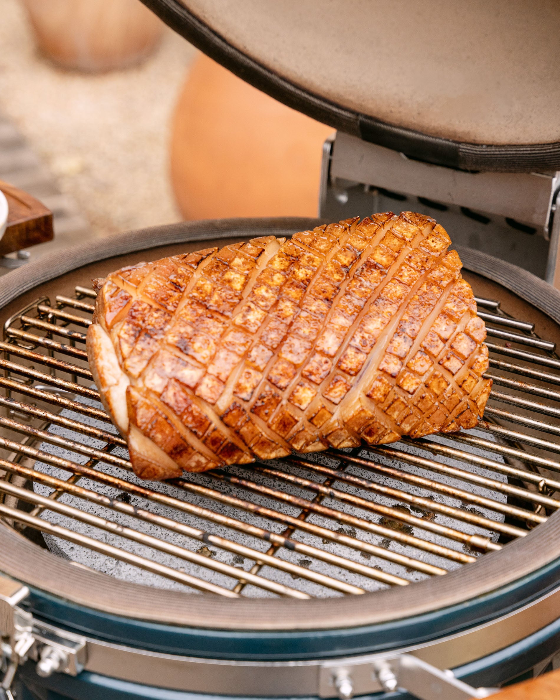 Roasting a pork loin on the grill of a Kokko kamado, lid open, with a golden, even sear.