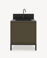 Outdoor kitchen module on stilts with integrated sink, olive green cabinet with closed storage, dark countertop and built-in backsplash.