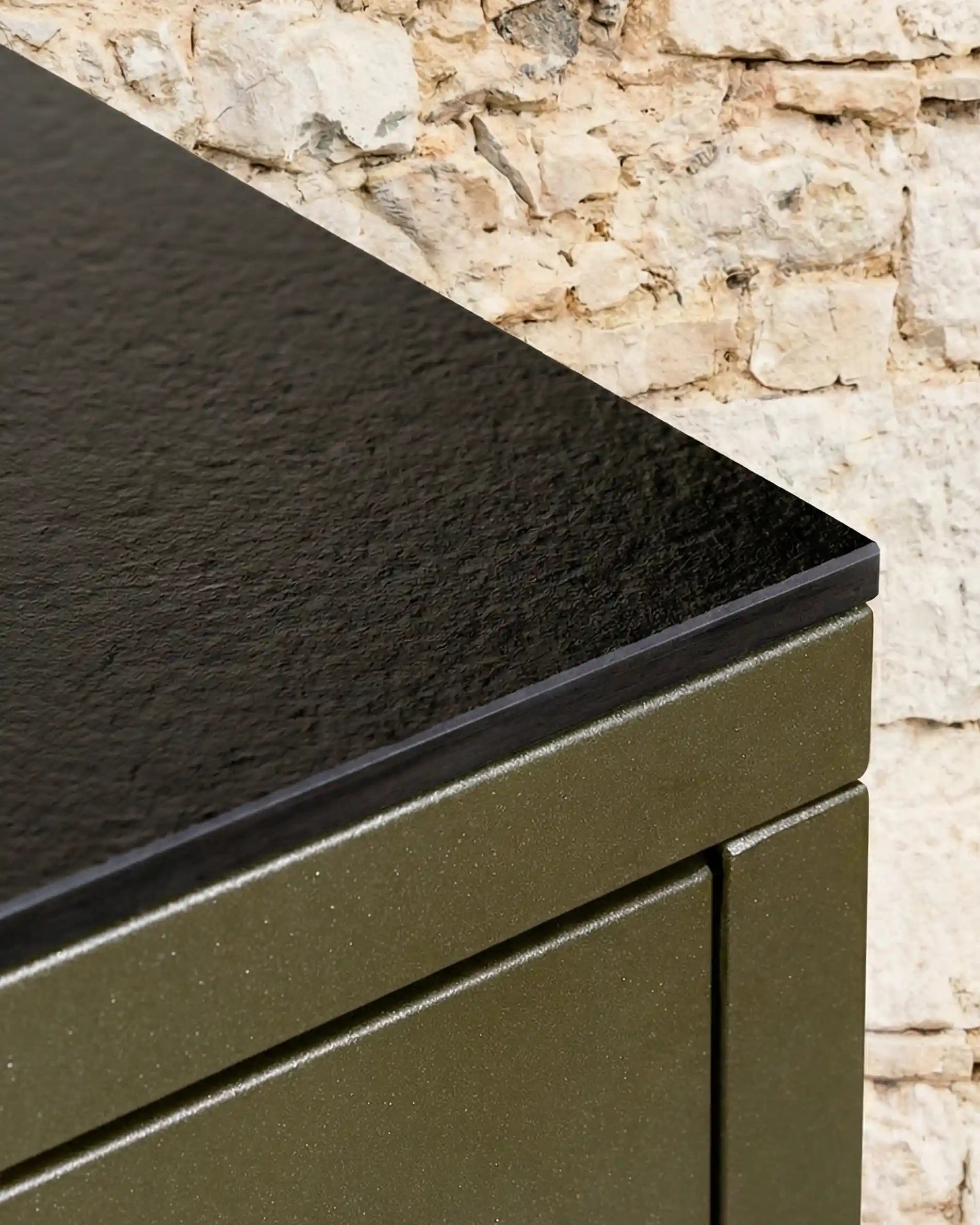 Textured black worktop detail of Kokko olive outdoor kitchen