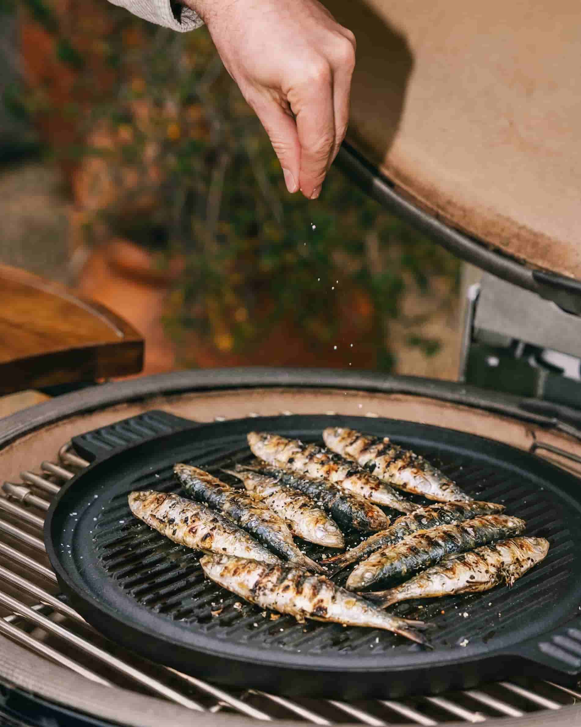 Cast iron plancha cooking plate on kamado