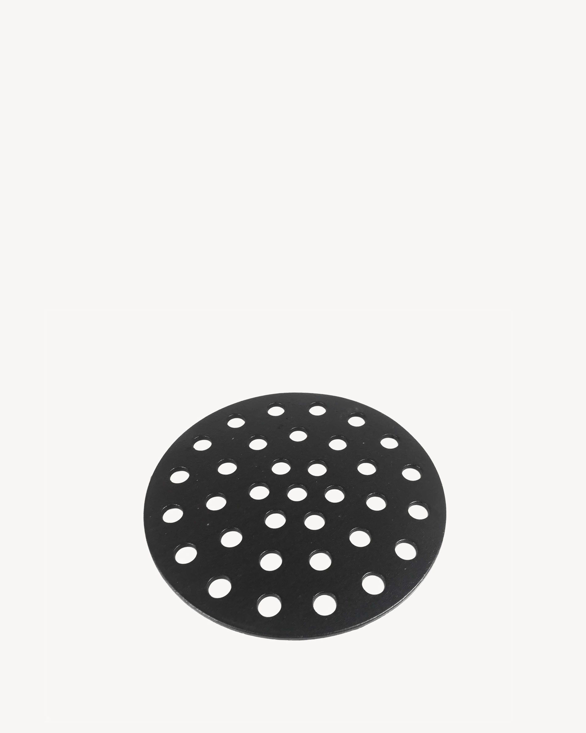 Perforated cast iron plate for charcoal management in the kamado.