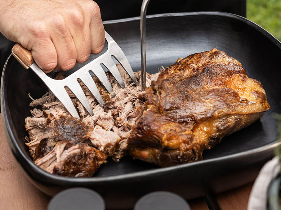 Pulled smoked pork on the Kokko kamado, highlighting the meat’s texture after slow cooking.
