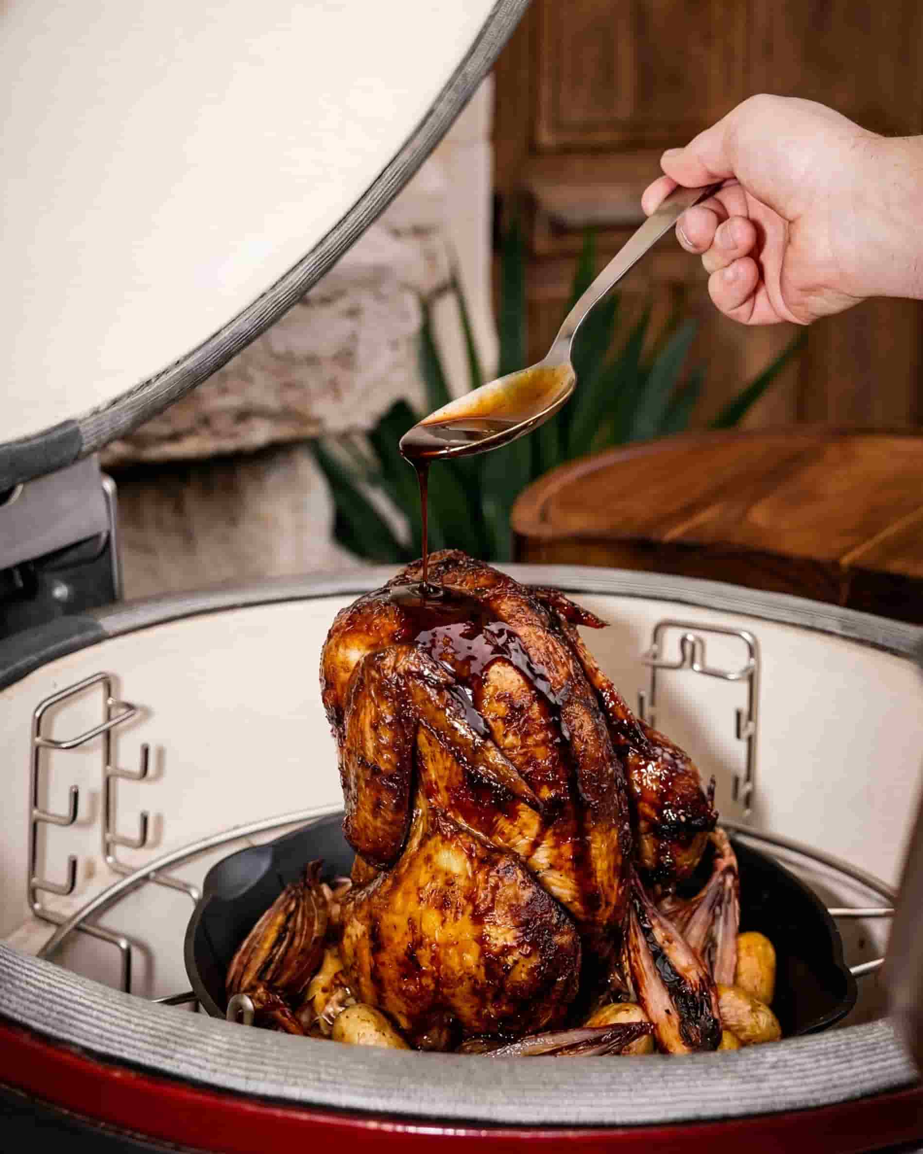 Cast iron poultry roaster with chicken